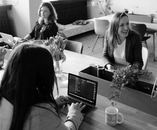 woman staffs of company sit on a table and work